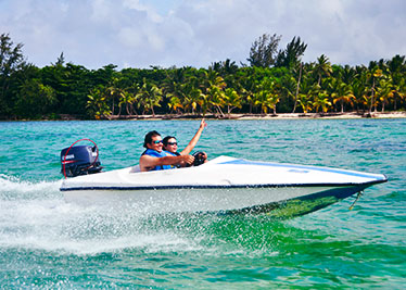 couple driving a speed boat